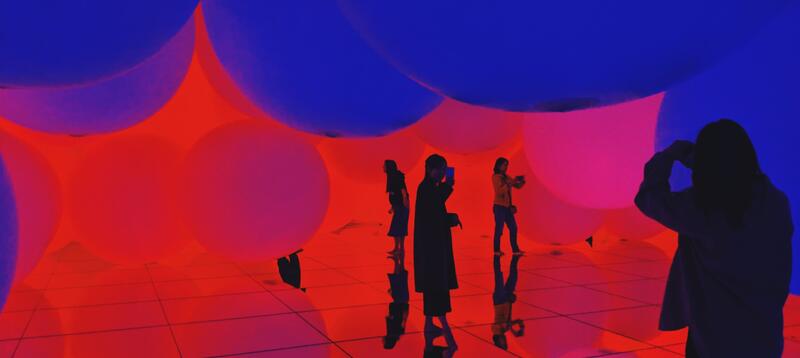 Women walking around in a immersive and colorful experience 